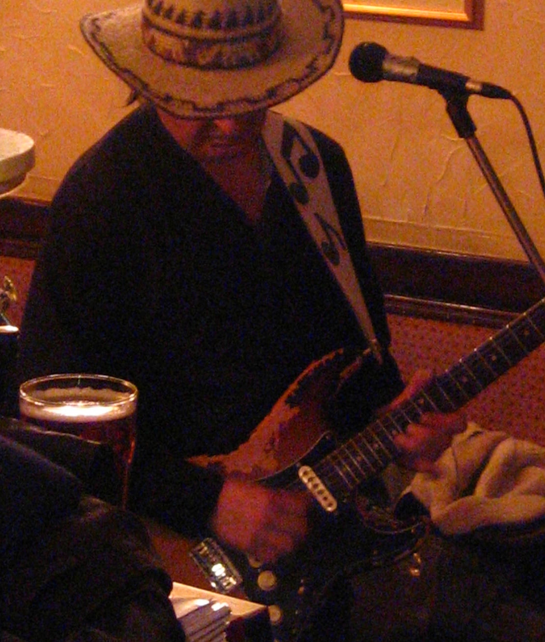 a man in a cowboy hat playing guitar