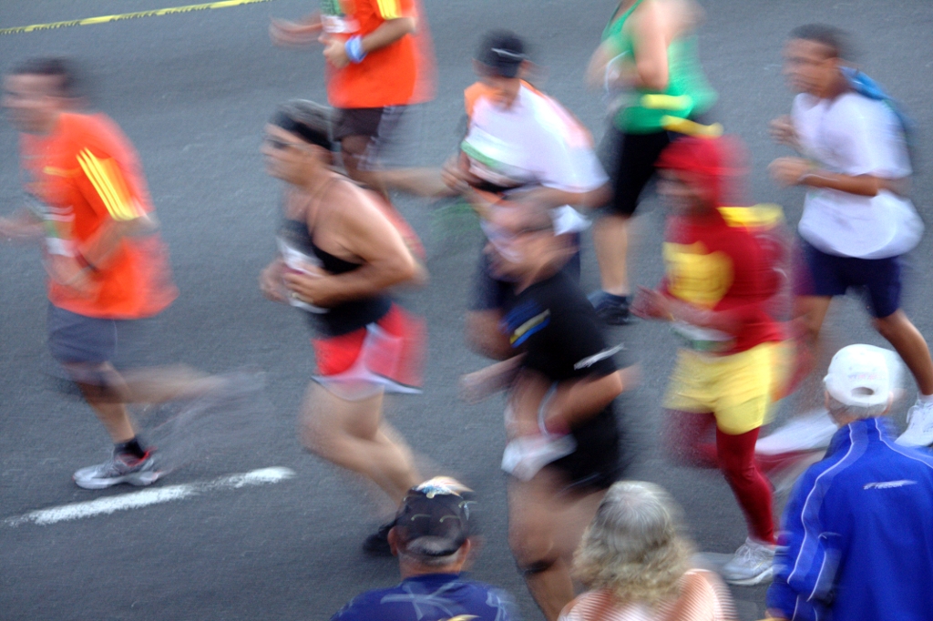 blurry po of marathon runners running through the street