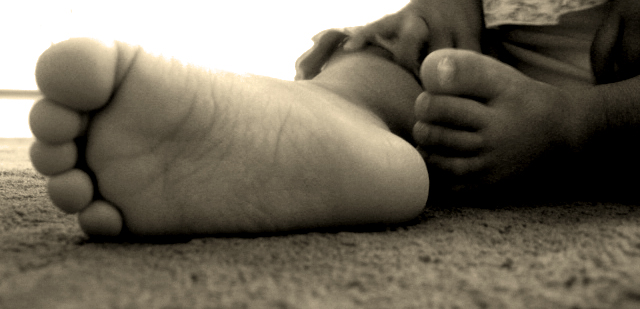 black and white image of a baby feet