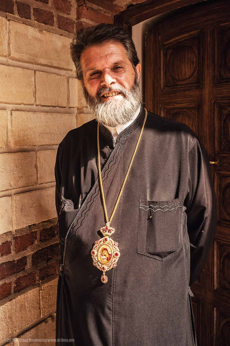 a man with a beard and beard jewelry
