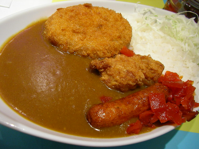 a meal consisting of sausage, rice, and some kind of fried meat