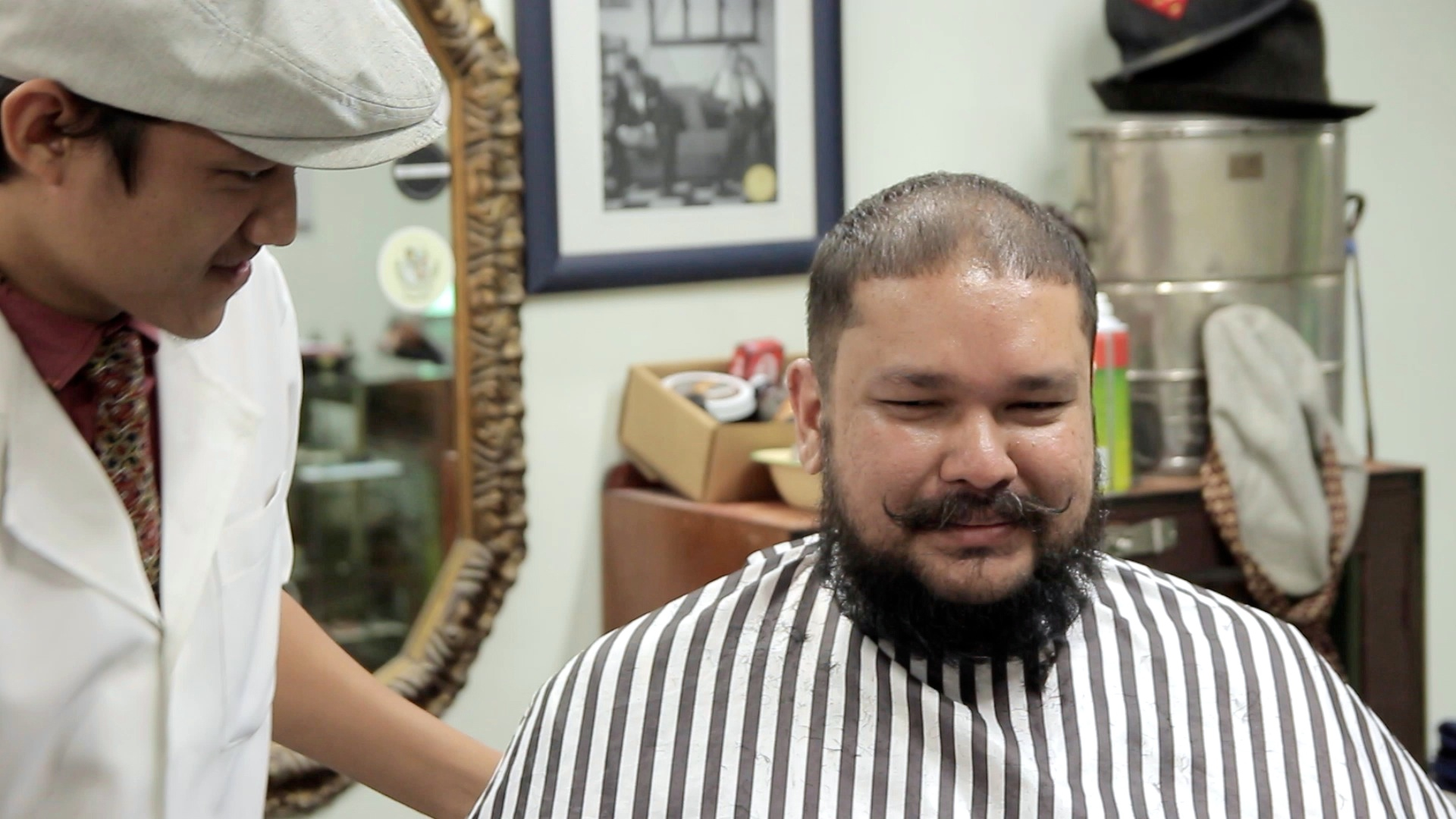 a man is shaving his hair in the barber shop