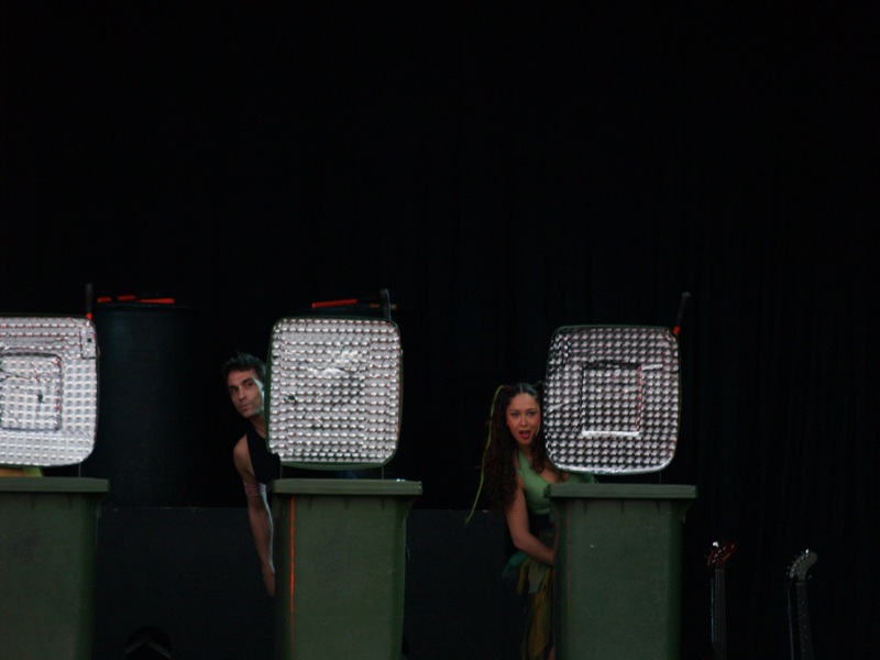 two women on stage with lamps and lights behind them