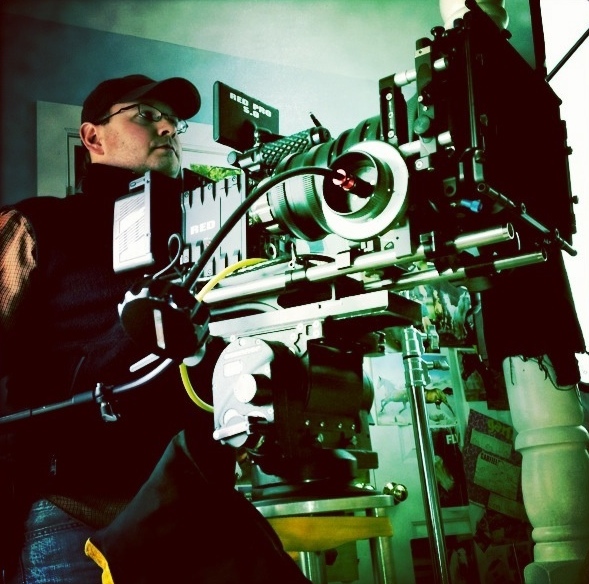 a man in glasses working on a machine