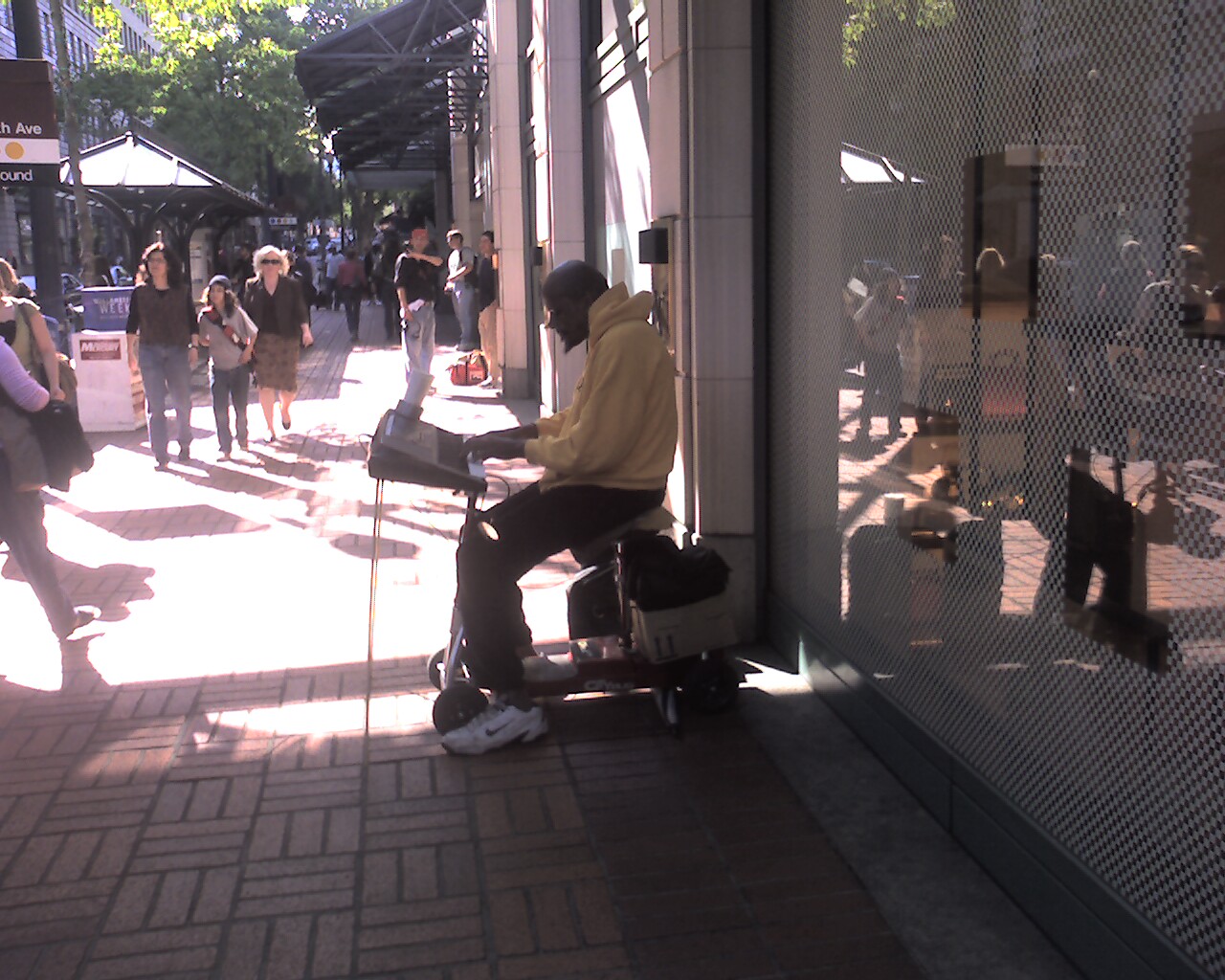 the man is playing guitar on the street