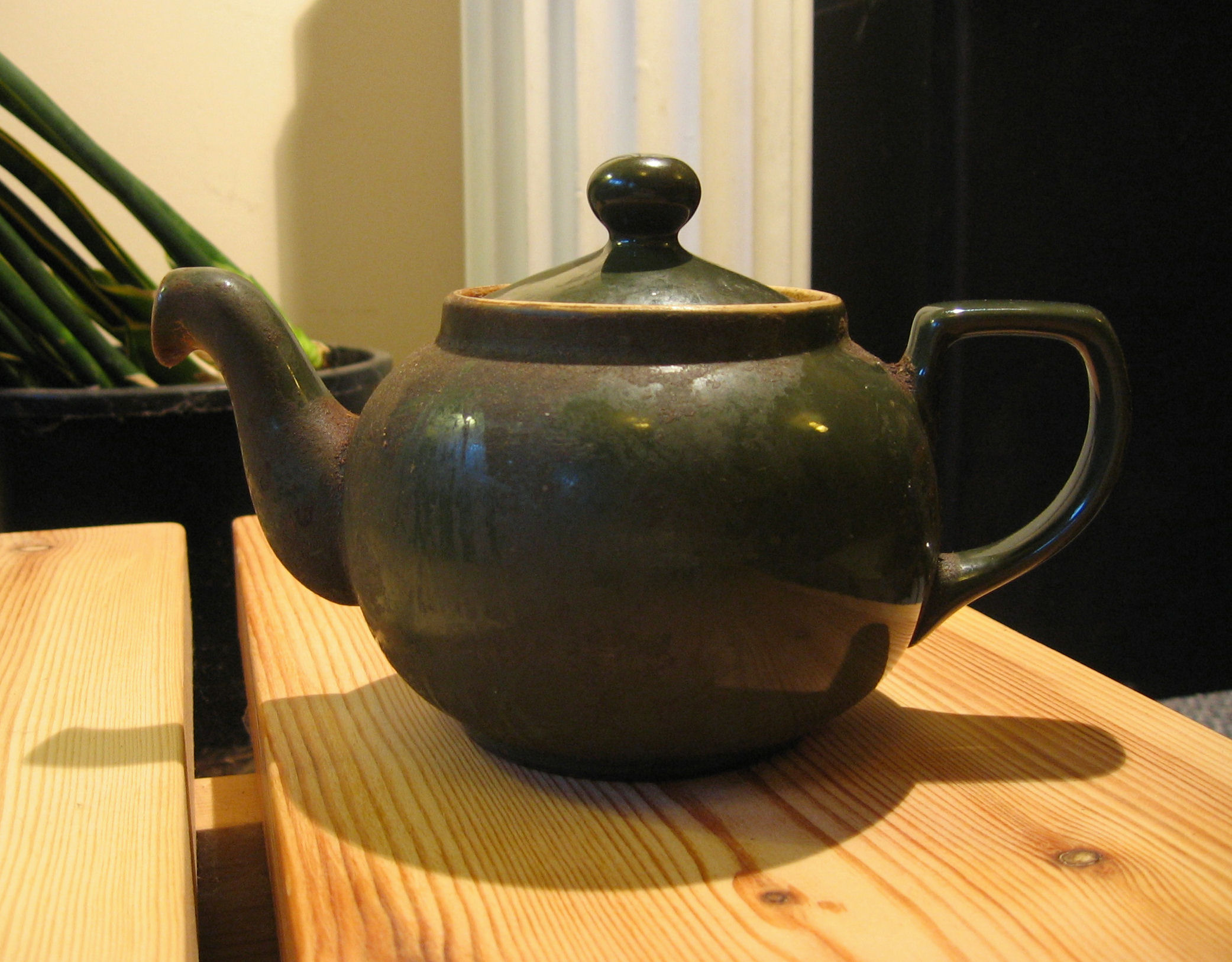 a ceramic teapot on a wooden surface