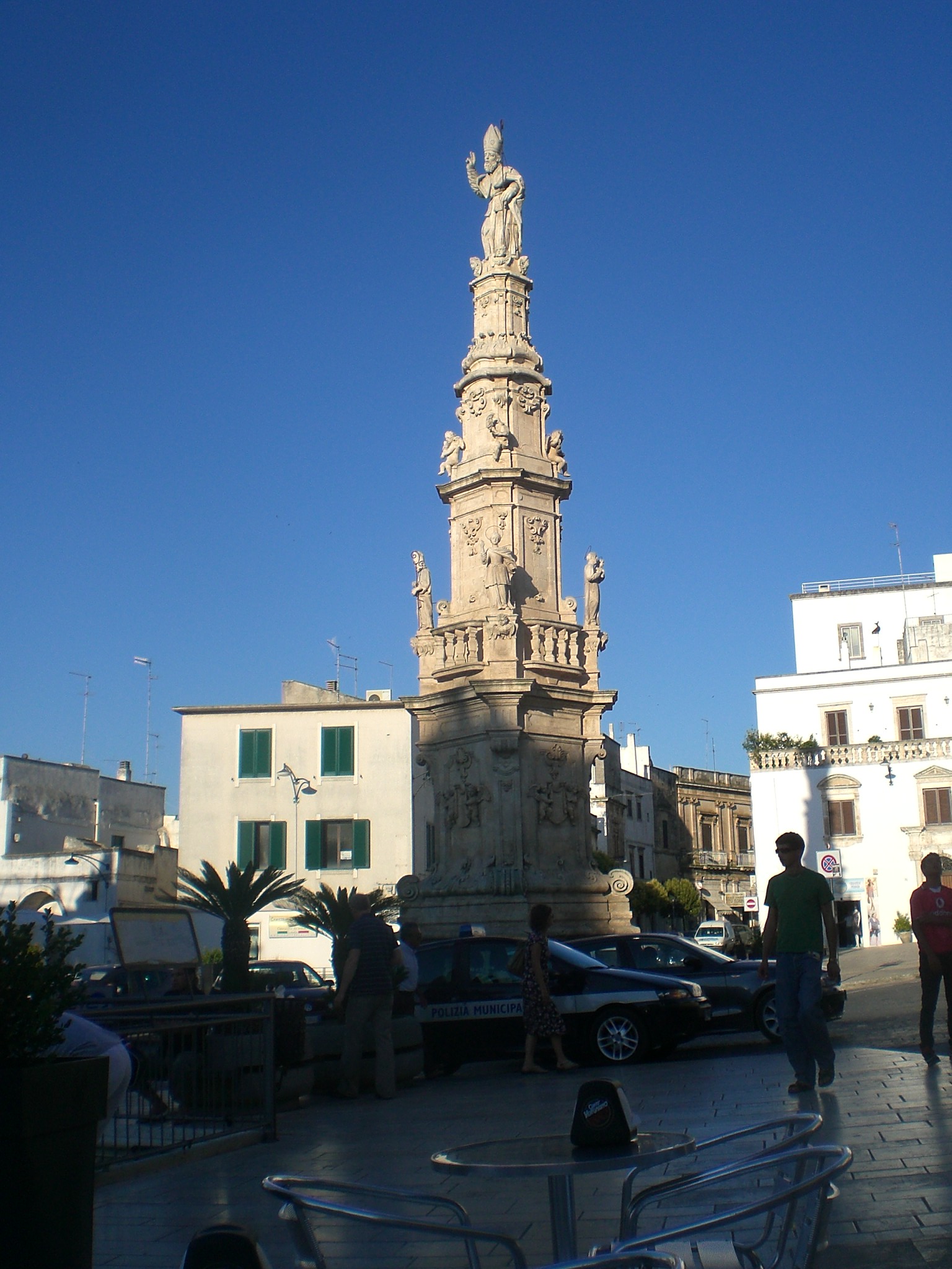 a very tall tower with statues on top