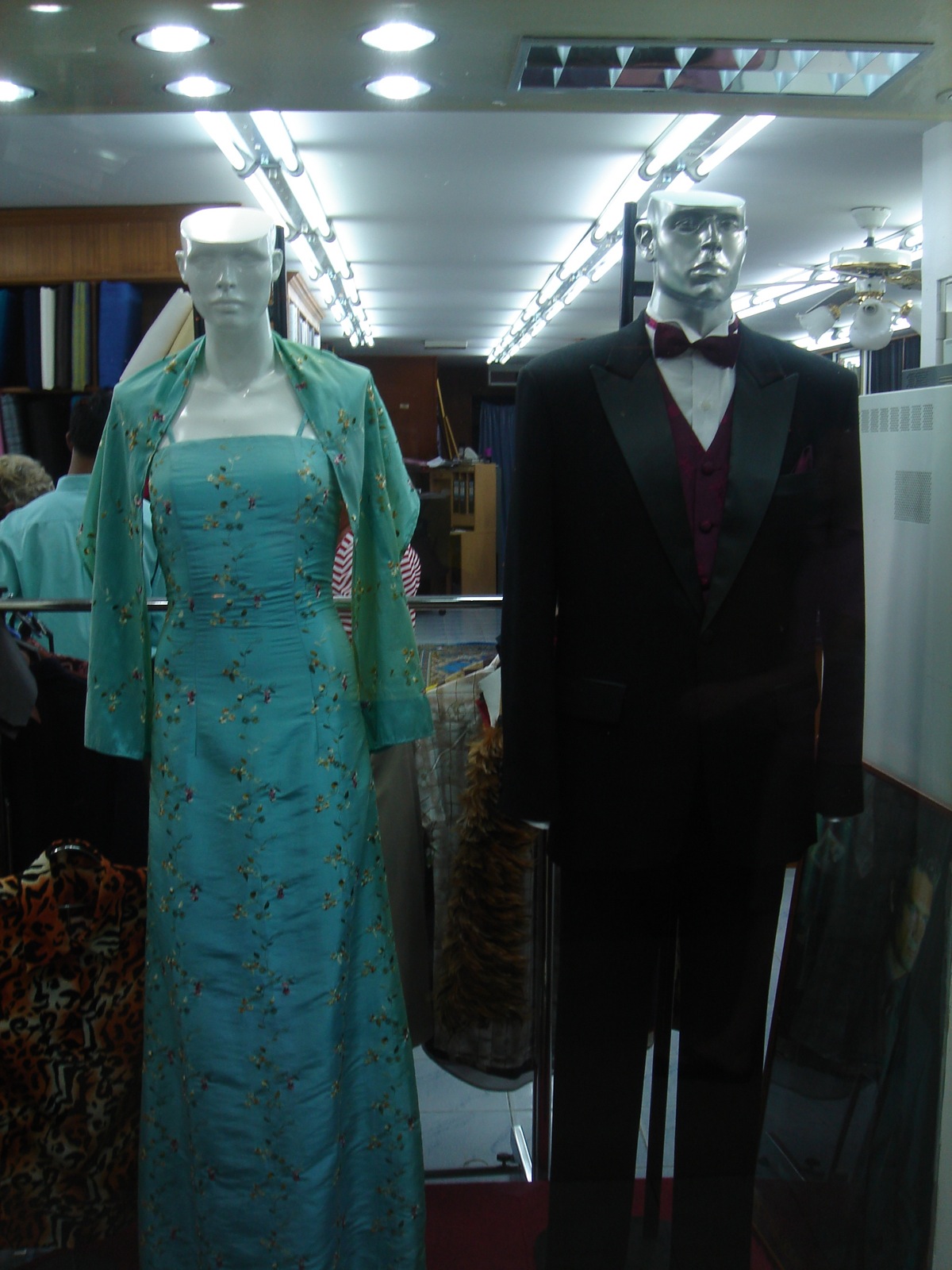 several clothes and mannequins are on display in a store