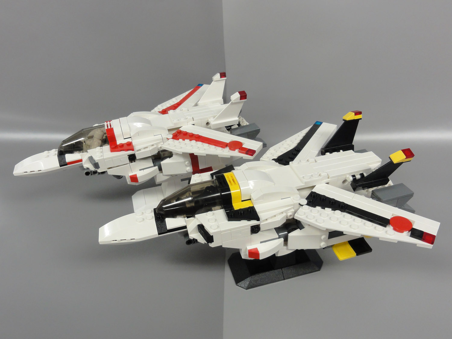 two lego fighter jets are set next to each other