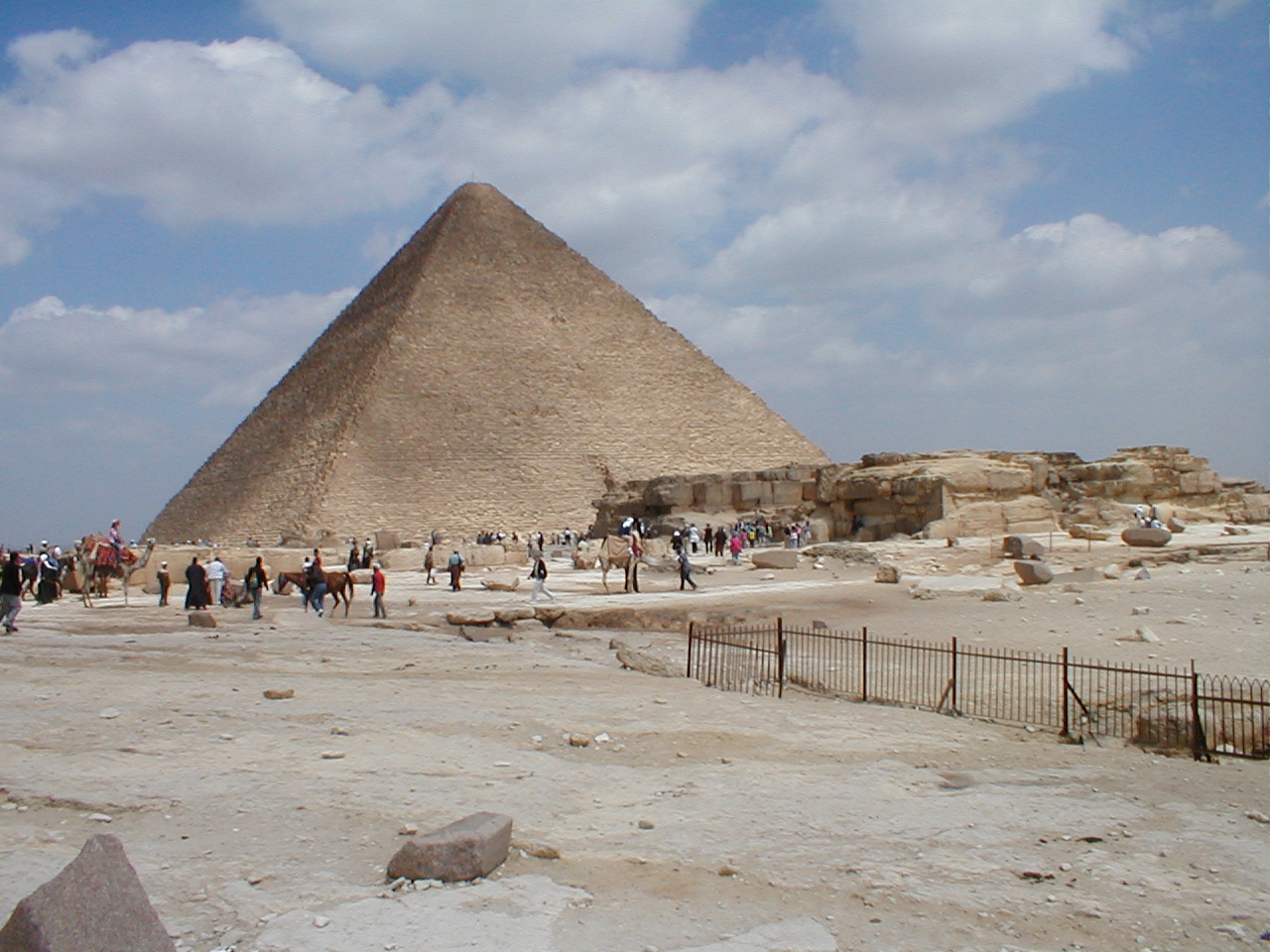 a group of people looking at a very large pyramid