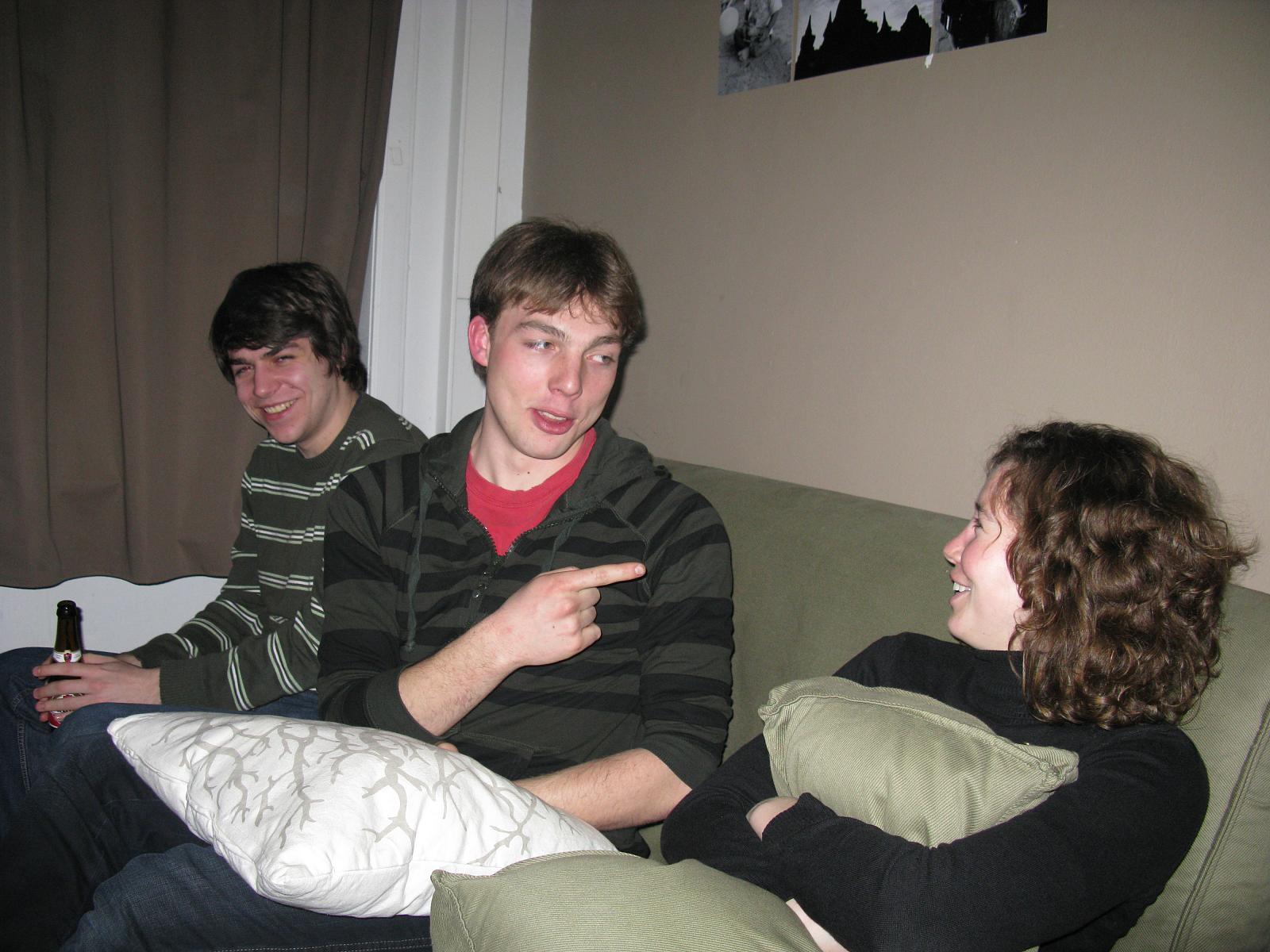 a couple of men sitting on top of a couch