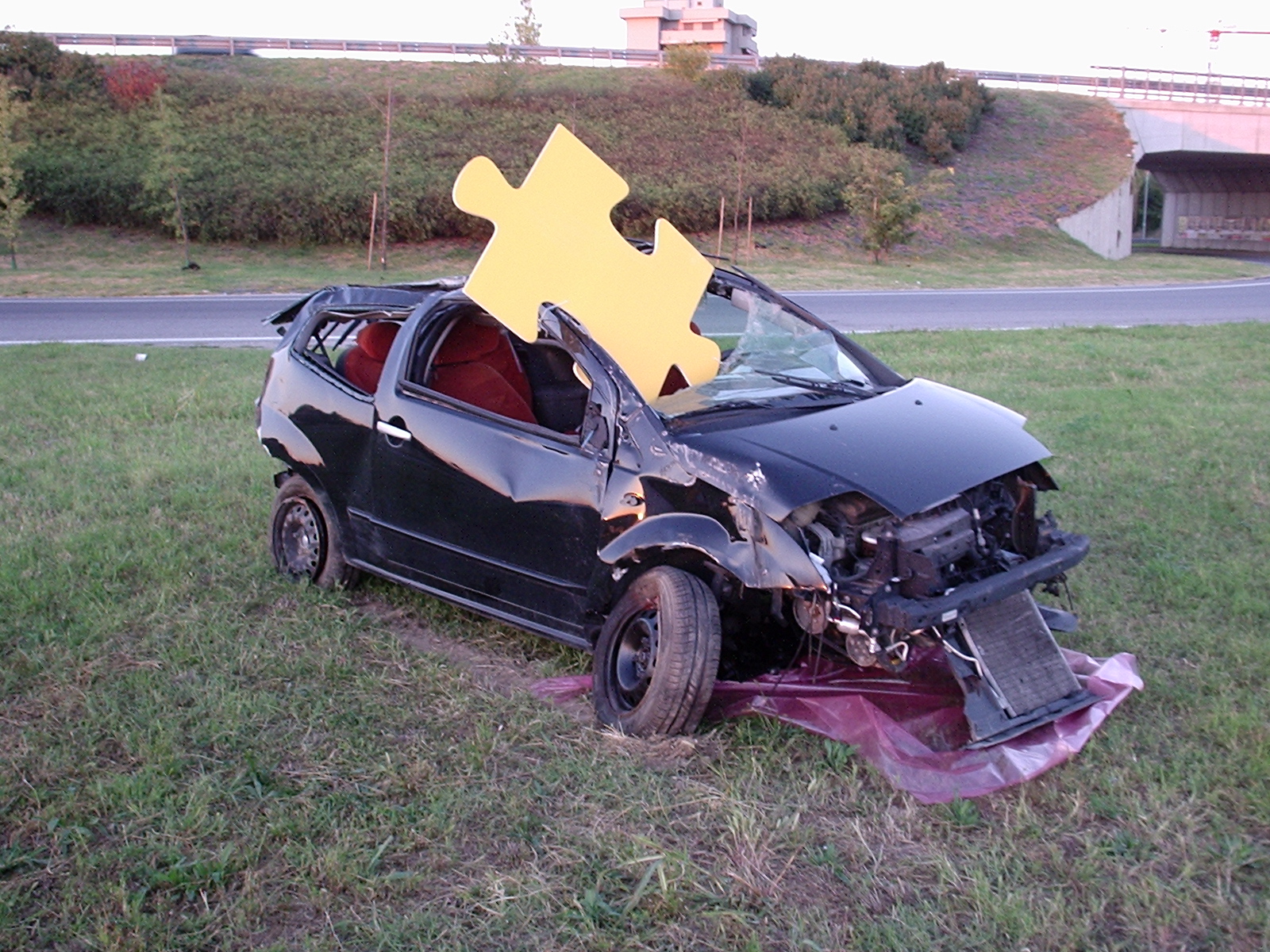 a car with its hood removed with puzzles on top