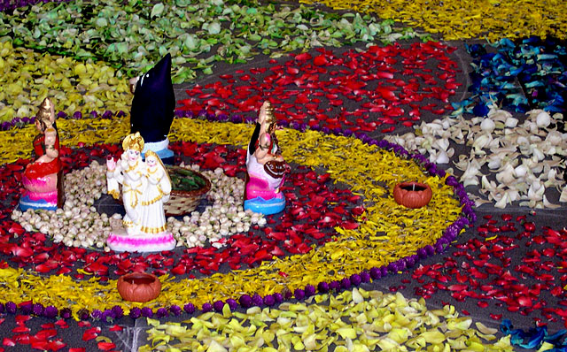a flower arrangement made of many flowers and small figurines