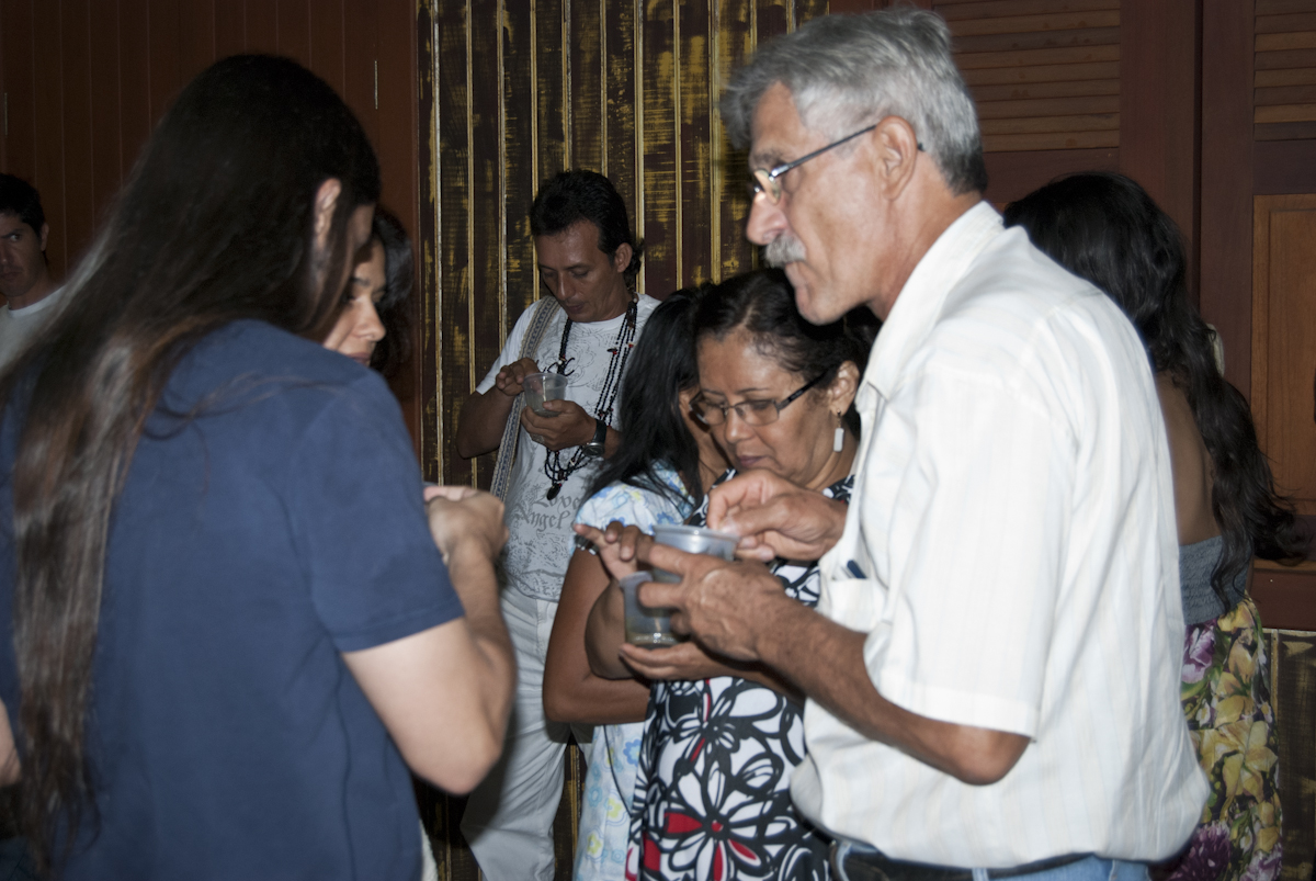 people are standing and laughing together while they hold smart phones