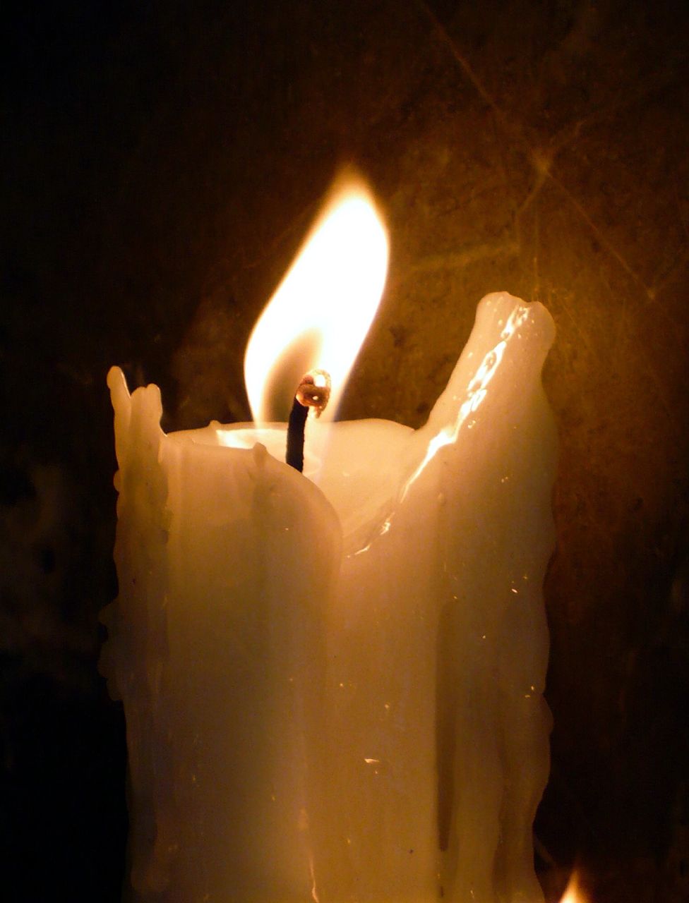 a candle with a light shining on top of it