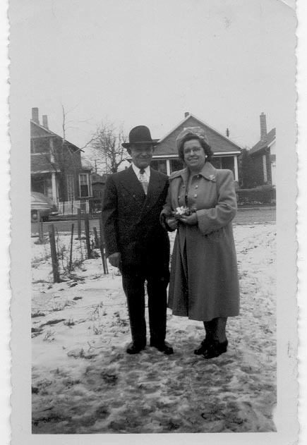 a man and woman standing on the snow