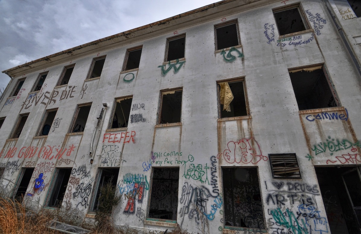 graffiti sprayed on the side of an old building