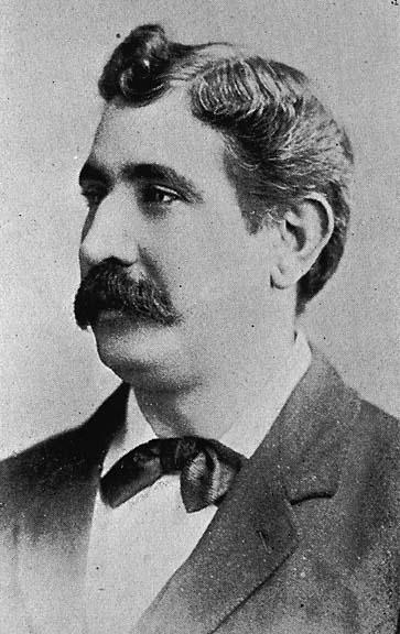 old pograph of a man with a mustache and a suit jacket