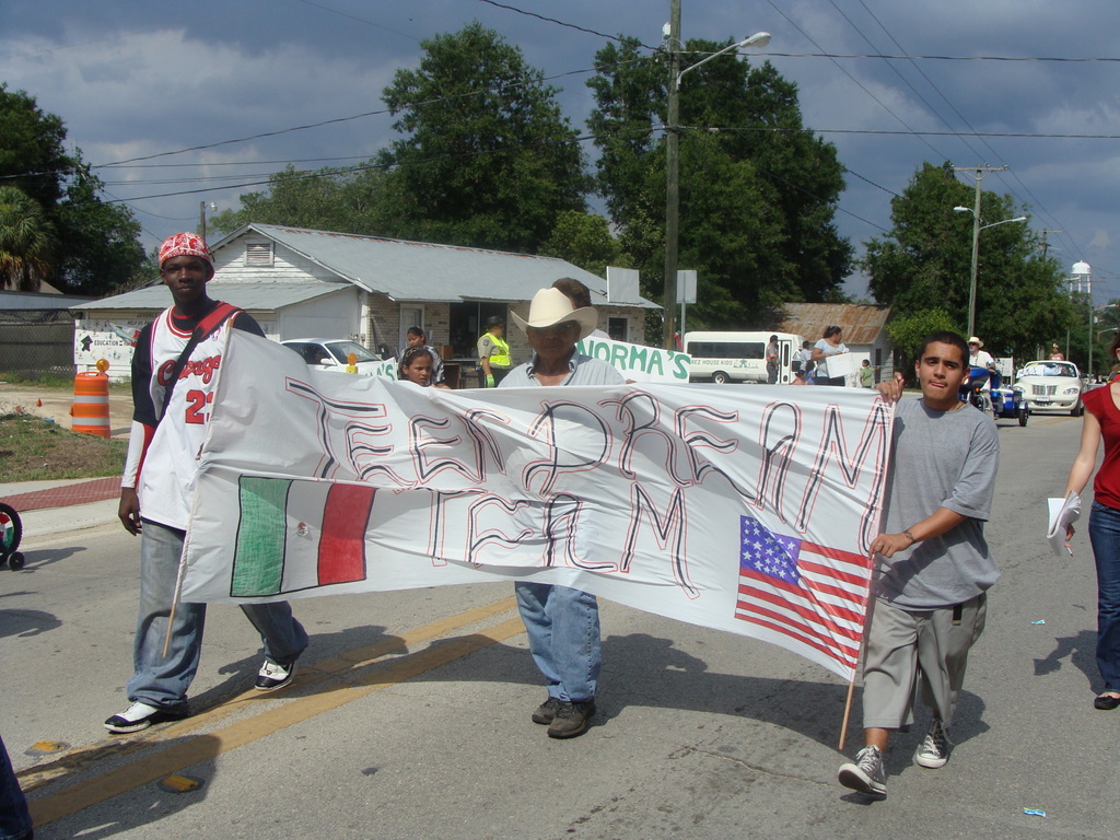 a group of people walking down the street with flags