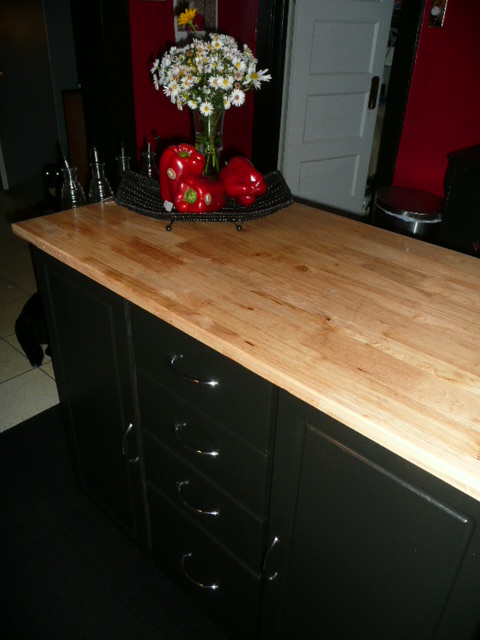 a wooden counter top in a kitchen area