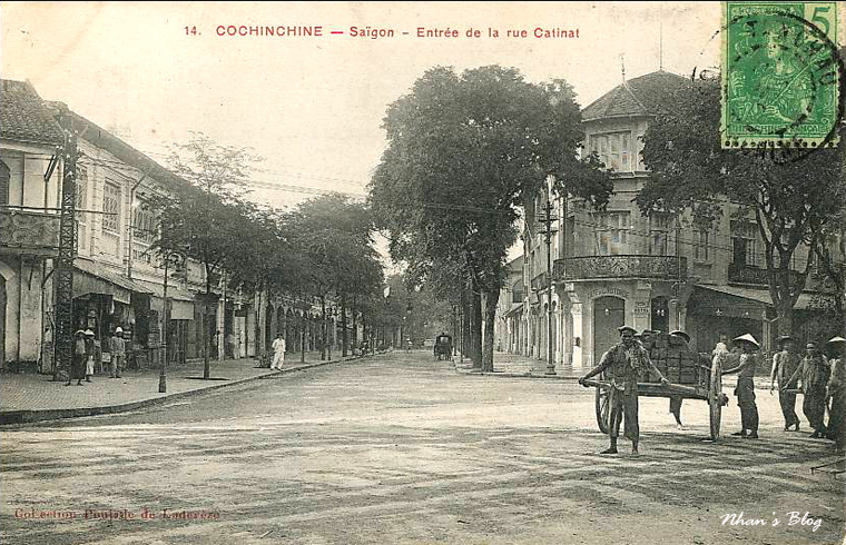 a man walking a horse and carriage down a street