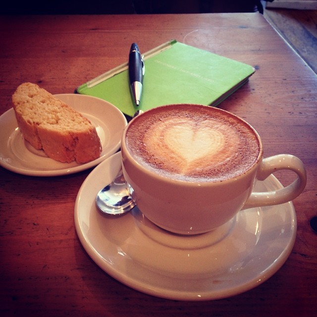 there is a cup of coffee and a loaf of bread