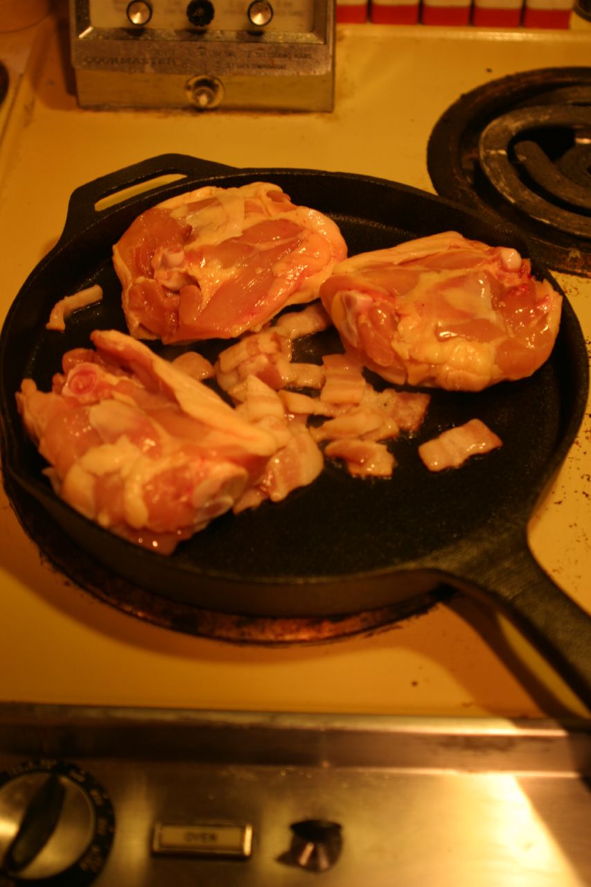 bacon is cooking in a set on a stove