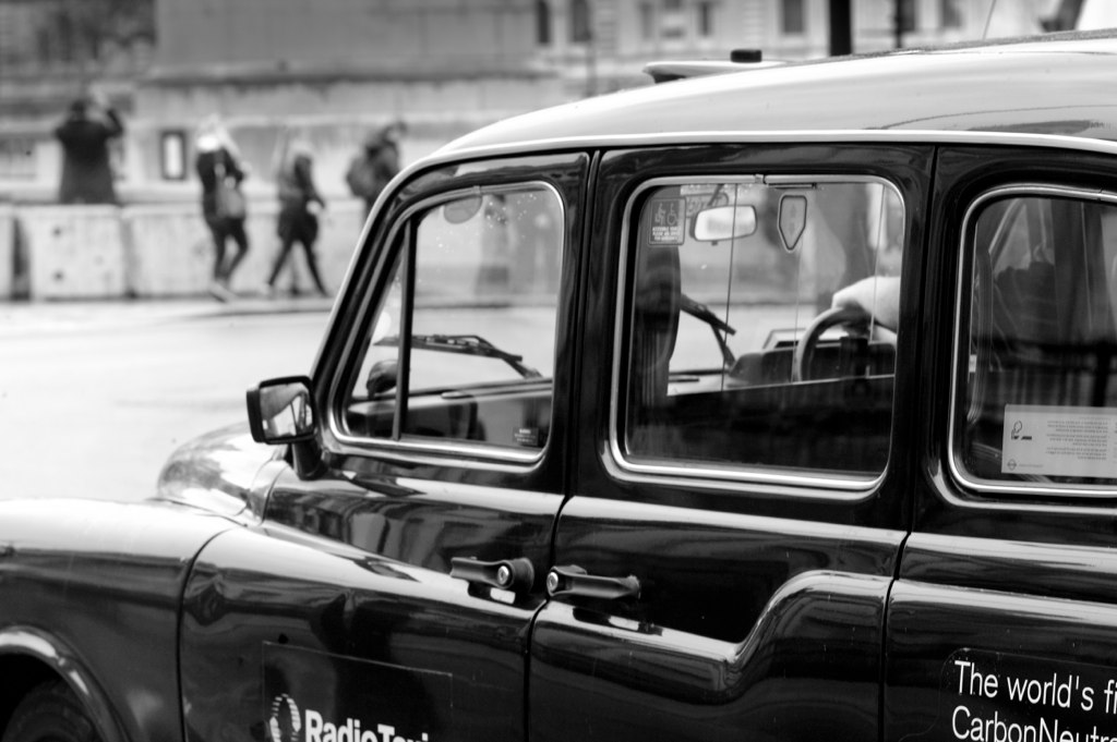 a black and white po of the door of an old school car