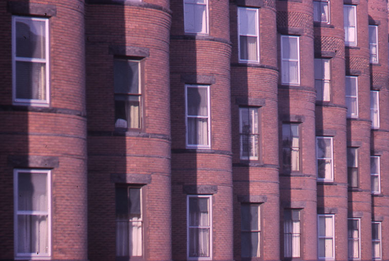 many windows on a building that is red brick