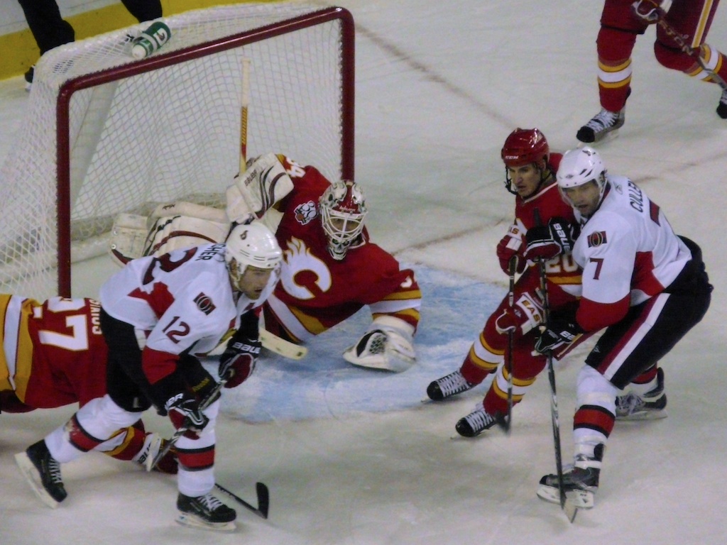 a hockey player going to block the puck