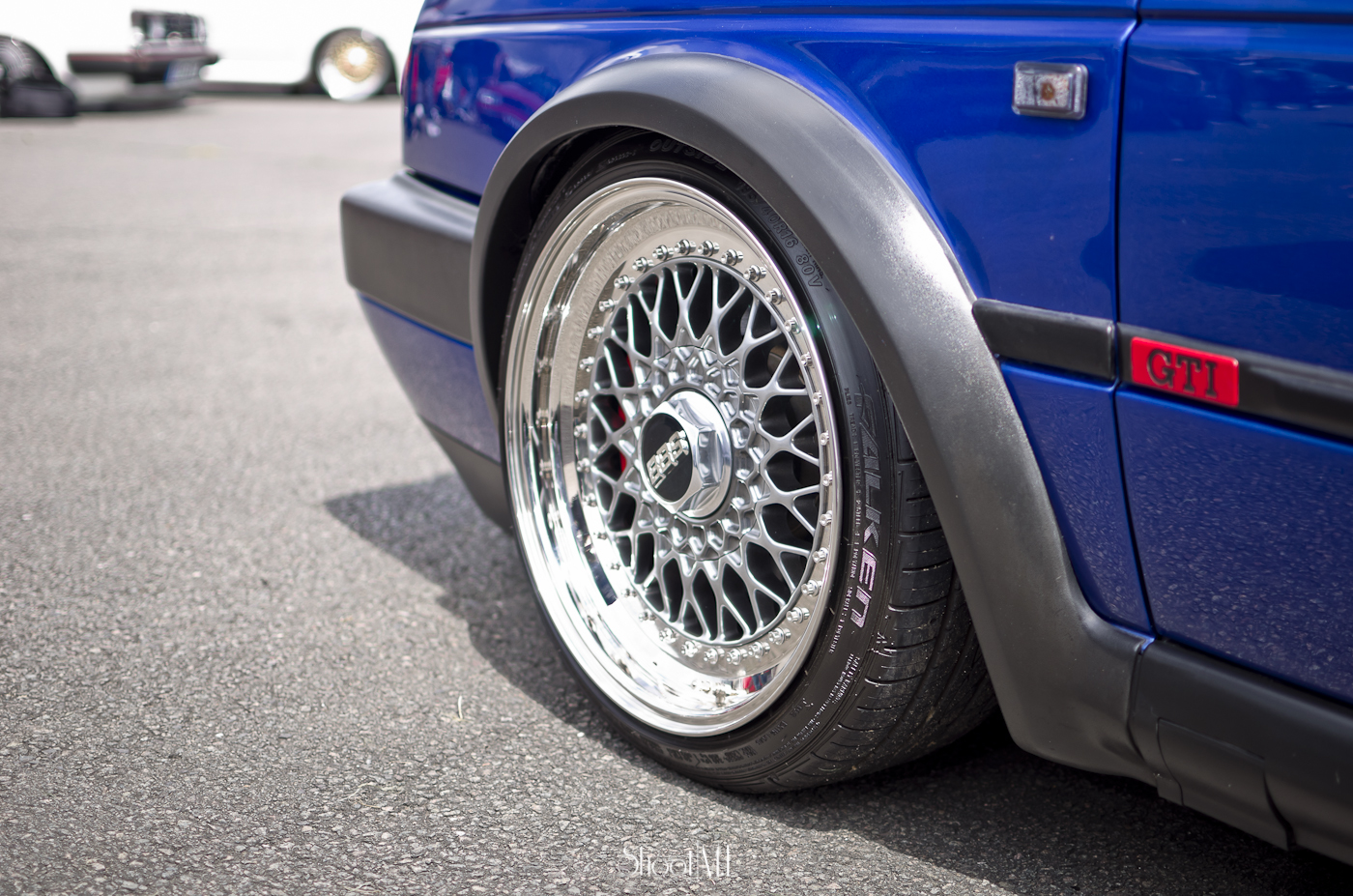 closeup of a car wheel with its rims painted blue