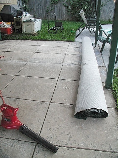 a piece of gray tarp next to a red pipe