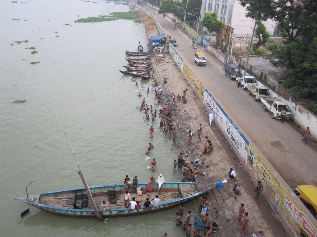 a large boat docked at the edge of a river