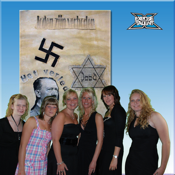 six people posing in front of an israeli mural