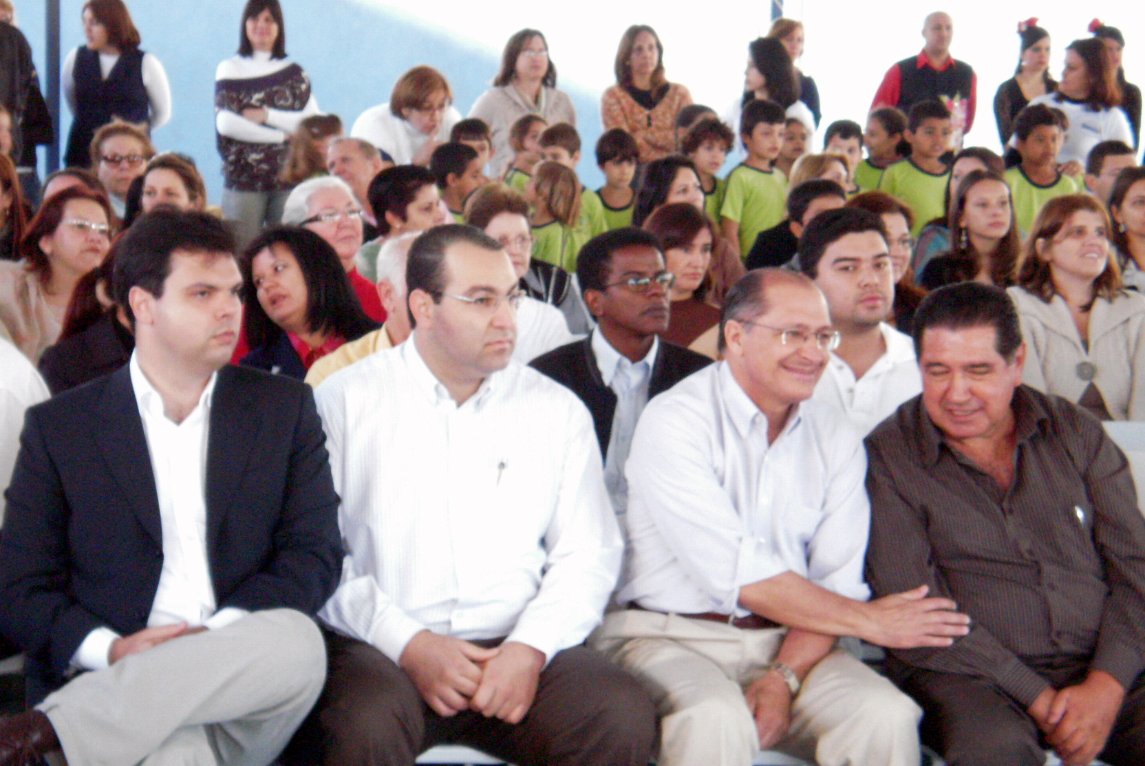 people sitting in front of a crowd at a religious event