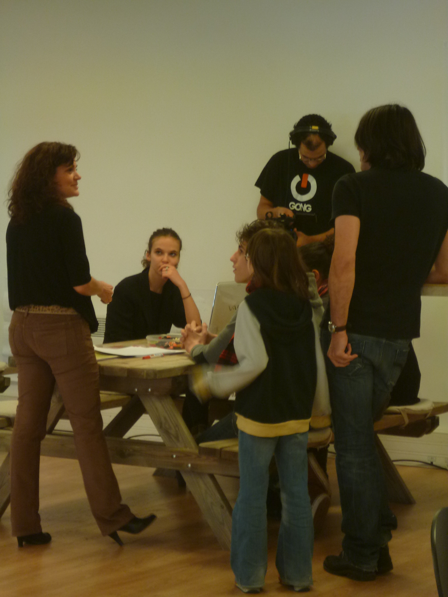 there are many people gathered around a small table