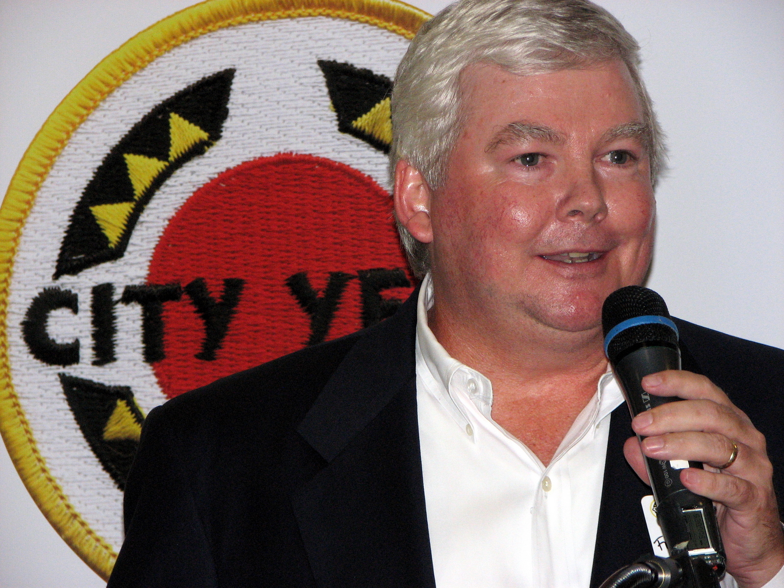 a man holding a microphone giving a speech