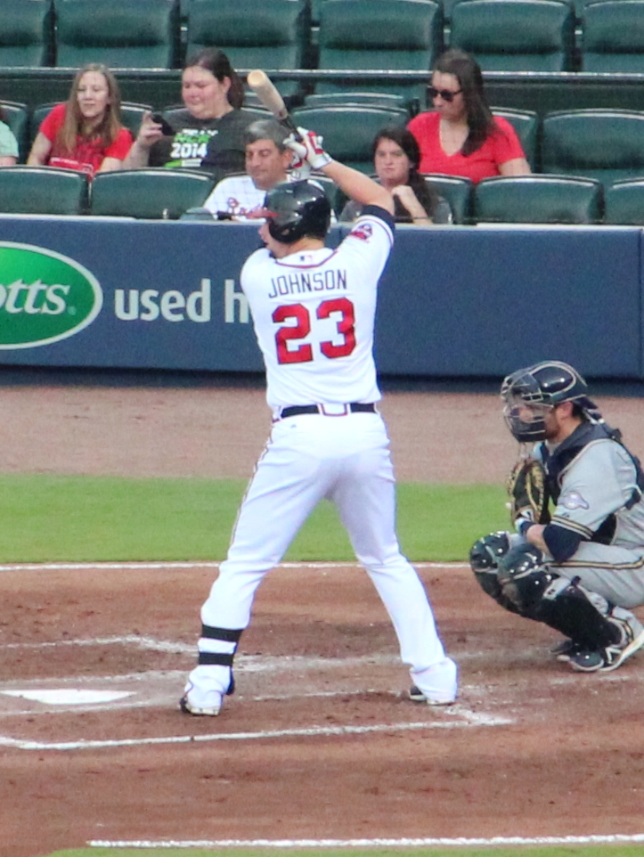 a baseball player holding a bat near home plate
