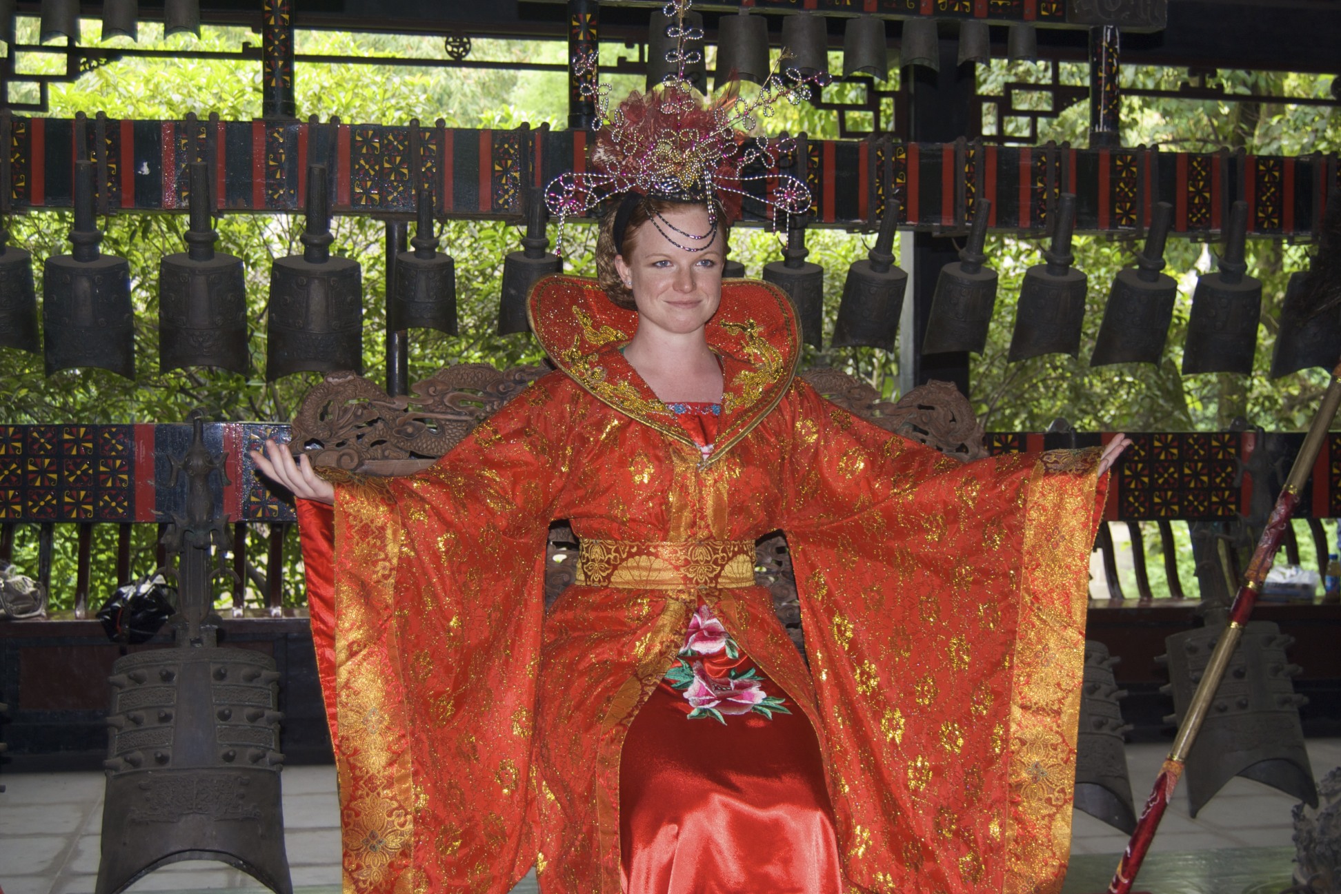 a woman in a red kimono is posing for the camera