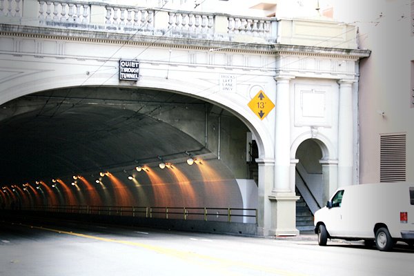 a white truck in a tunnel on the road