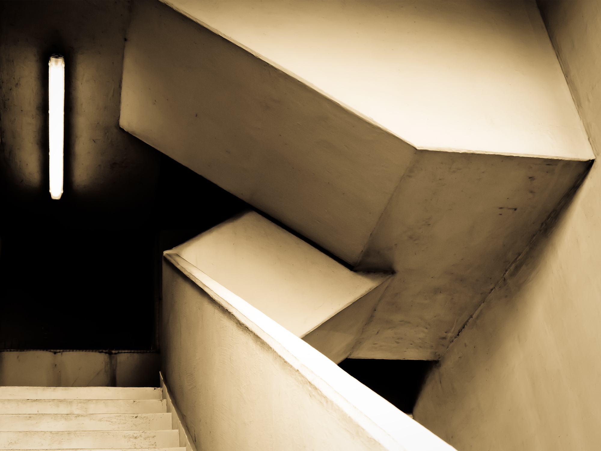 a stair with white walls and cement steps
