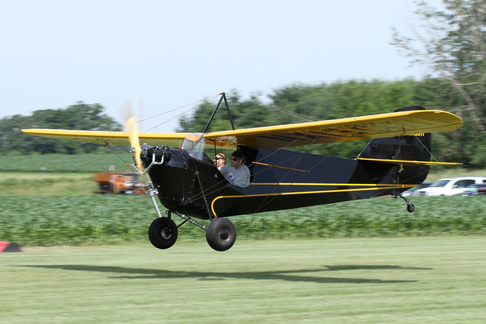 a person flying a small plane in the air