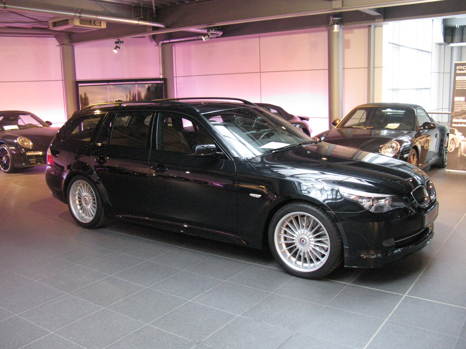 the cars are parked near each other in a showroom