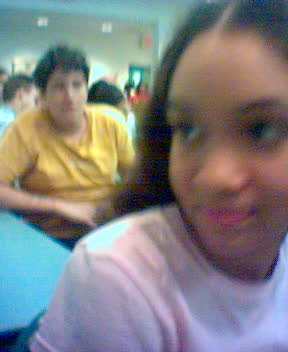 girl wearing pink shirt looking surprised in foreground