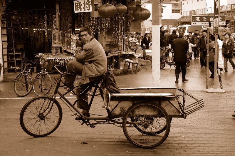 a man is riding a bike down the street