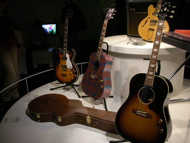 a couple of guitars that are sitting on display