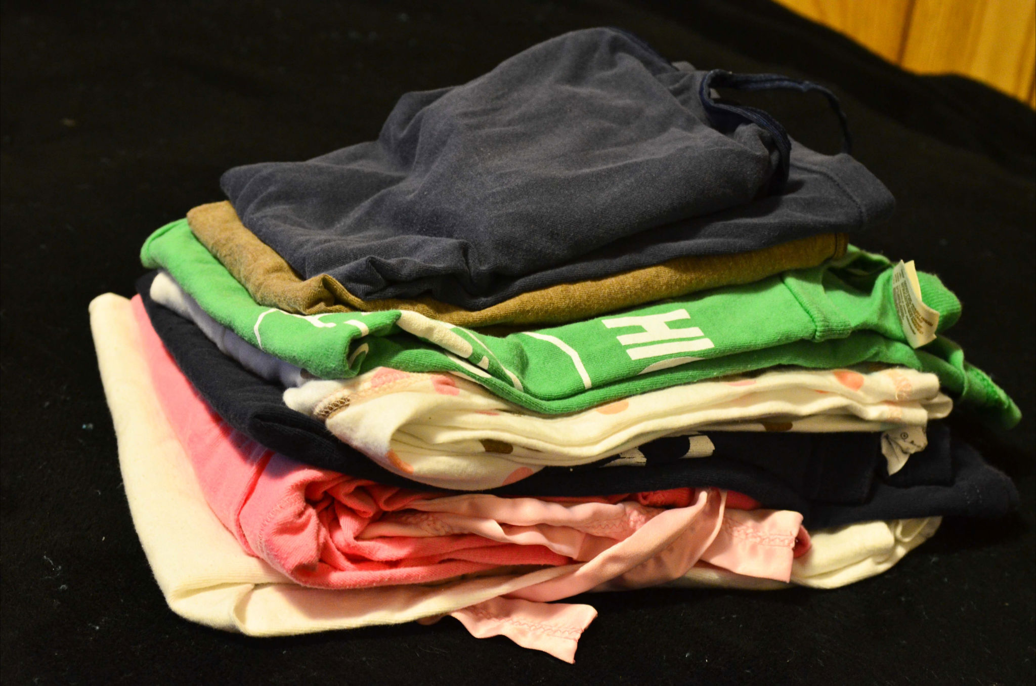 the clothes are folded up on the black table