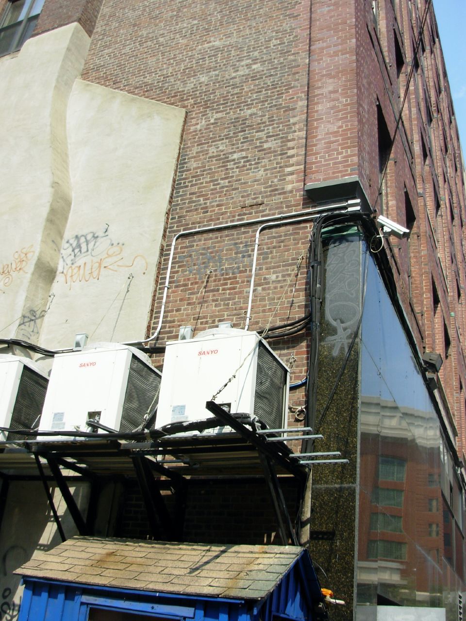 an old building on the street with trash trucks parked next to it