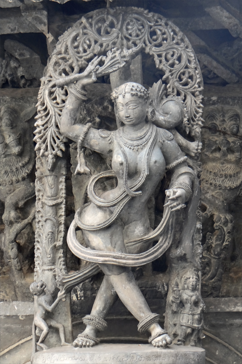 the statue depicts a person with a sword and an instrument