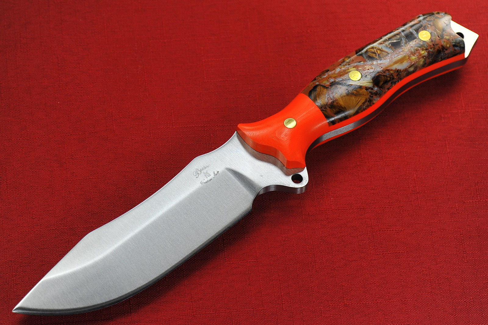 a knife on a red surface and a red background